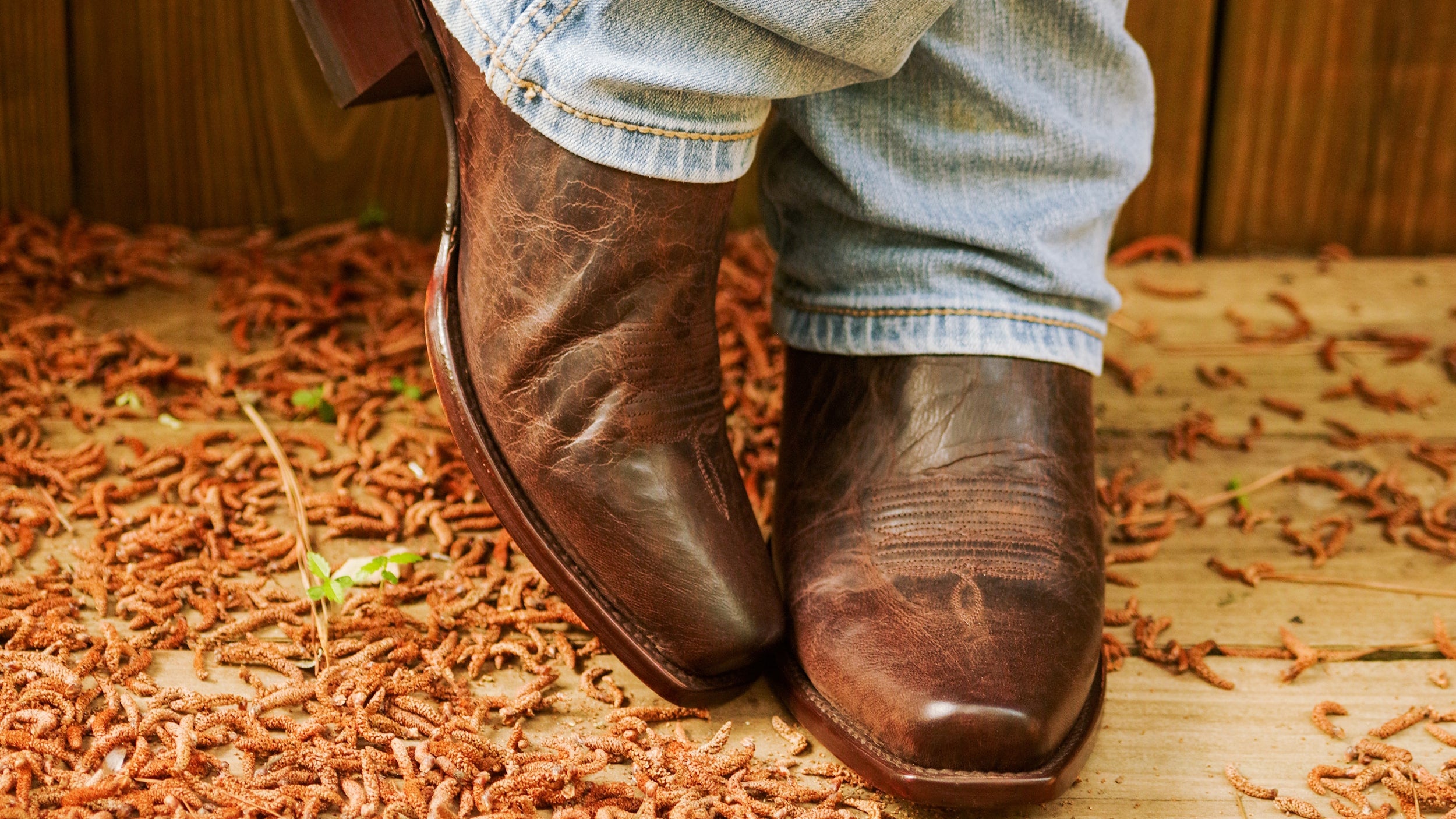 Man wearing RUJO 7-Toe Cowboy Boots standing with legs crossed