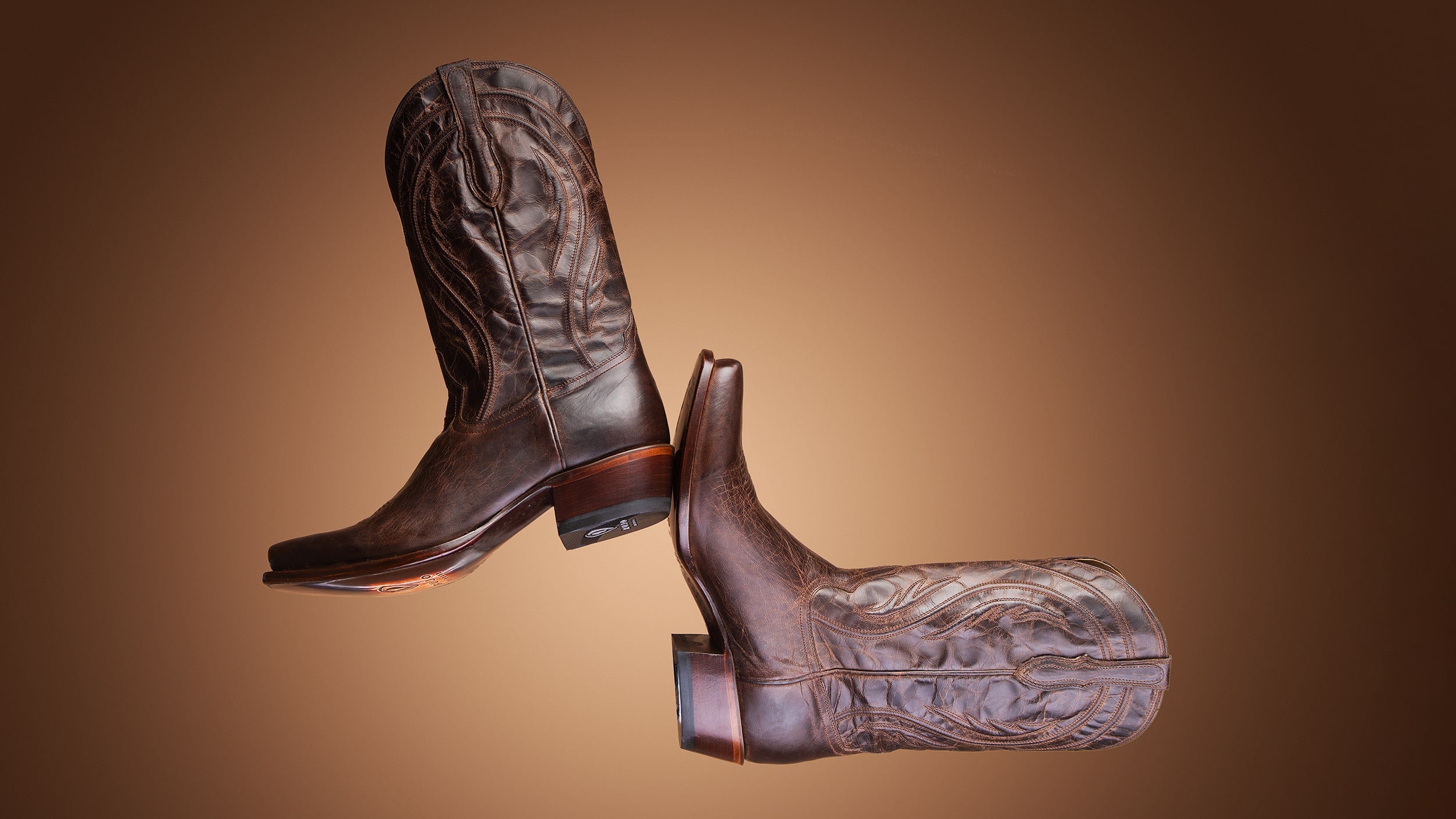 A pair of RUJO Mad Dog Leather cowboy boots in the studio