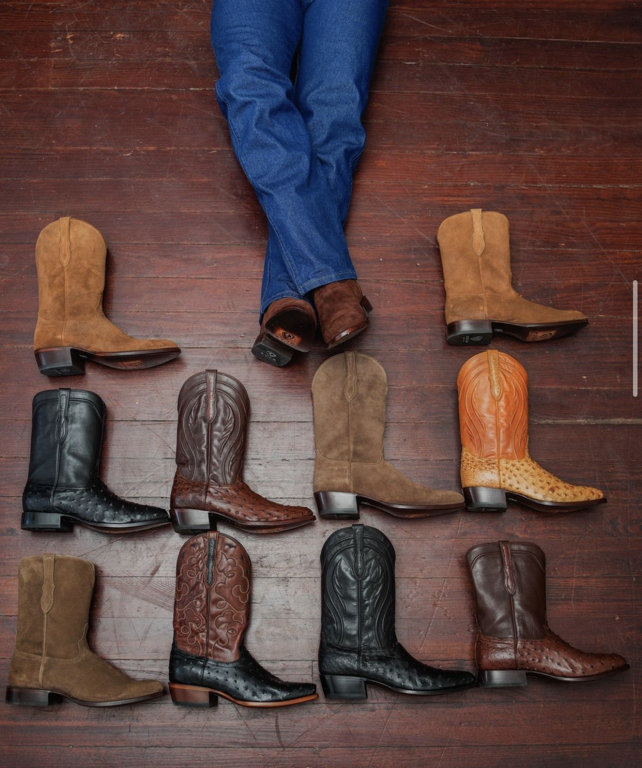 Top-down view of RUJO cowboy boots laid out on the floor
