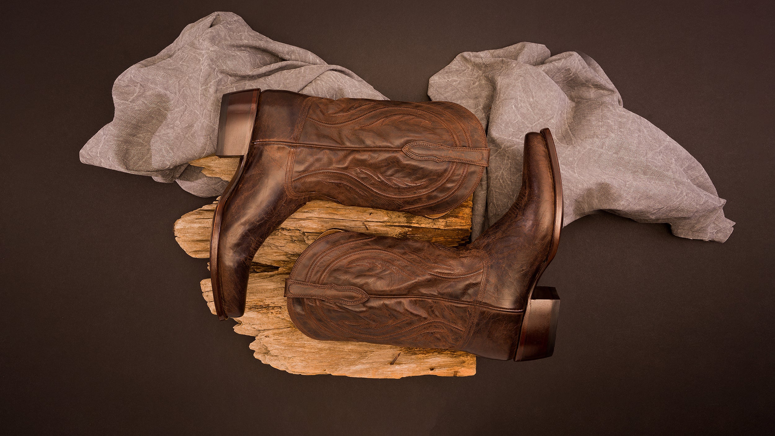Pair of RUJO boots the Tate on display on a log